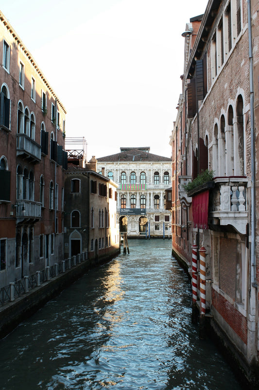river between concrete buildings during daytime