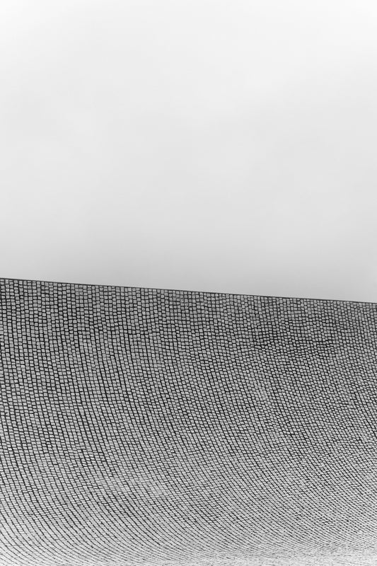 a man riding a surfboard on top of a wave covered beach